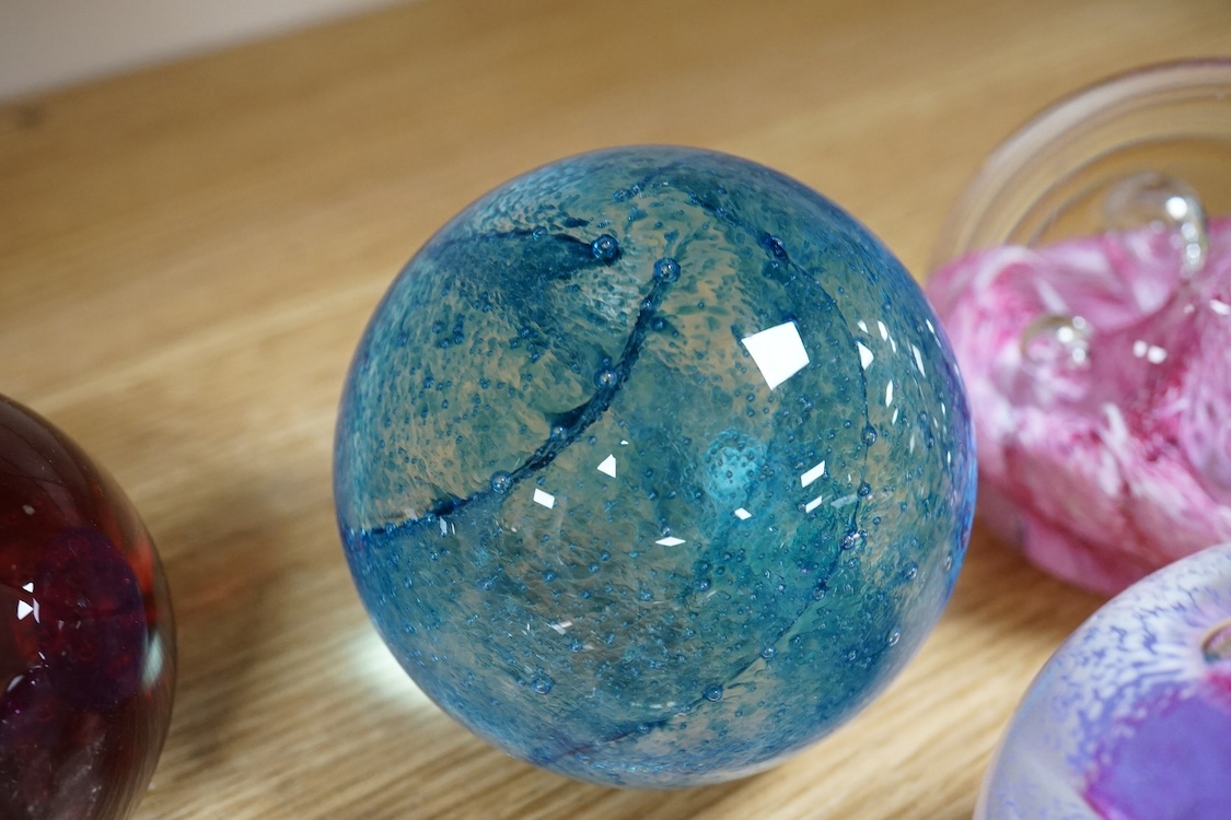 A collection of glass paperweights to include Caithness and millefiori examples, largest 10cm high